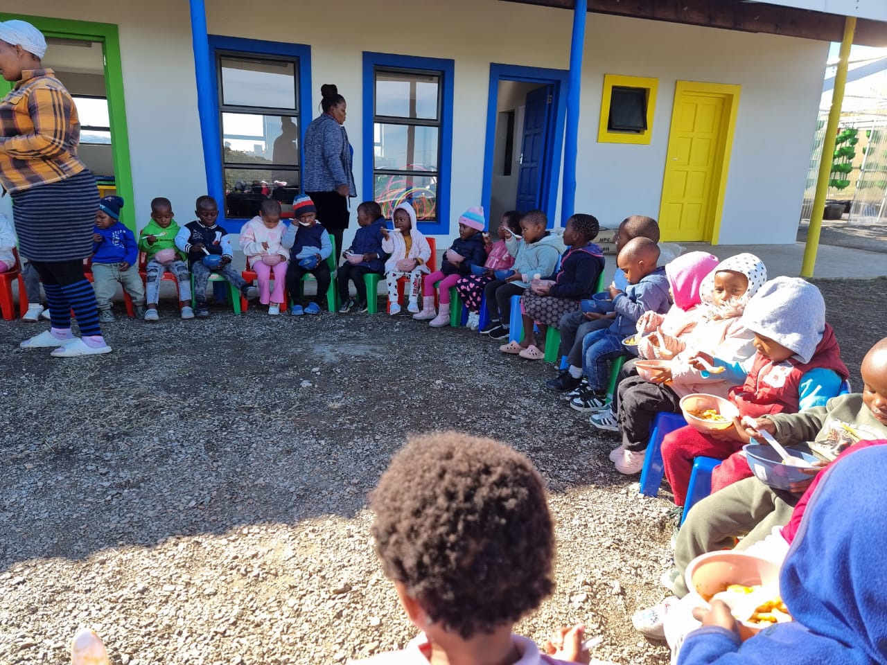Children eating together in a circle
