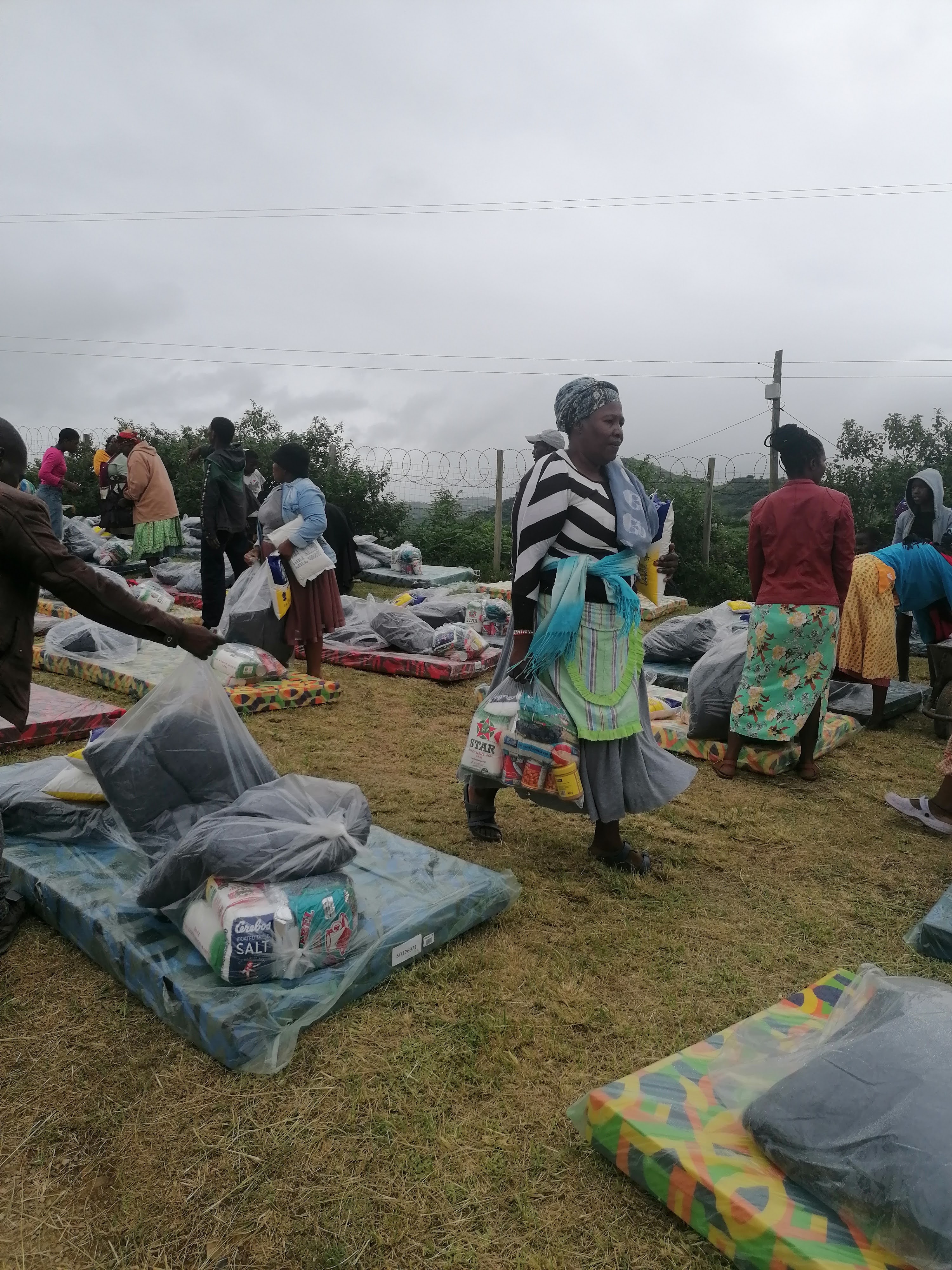 Families receiving mattresses and relief items