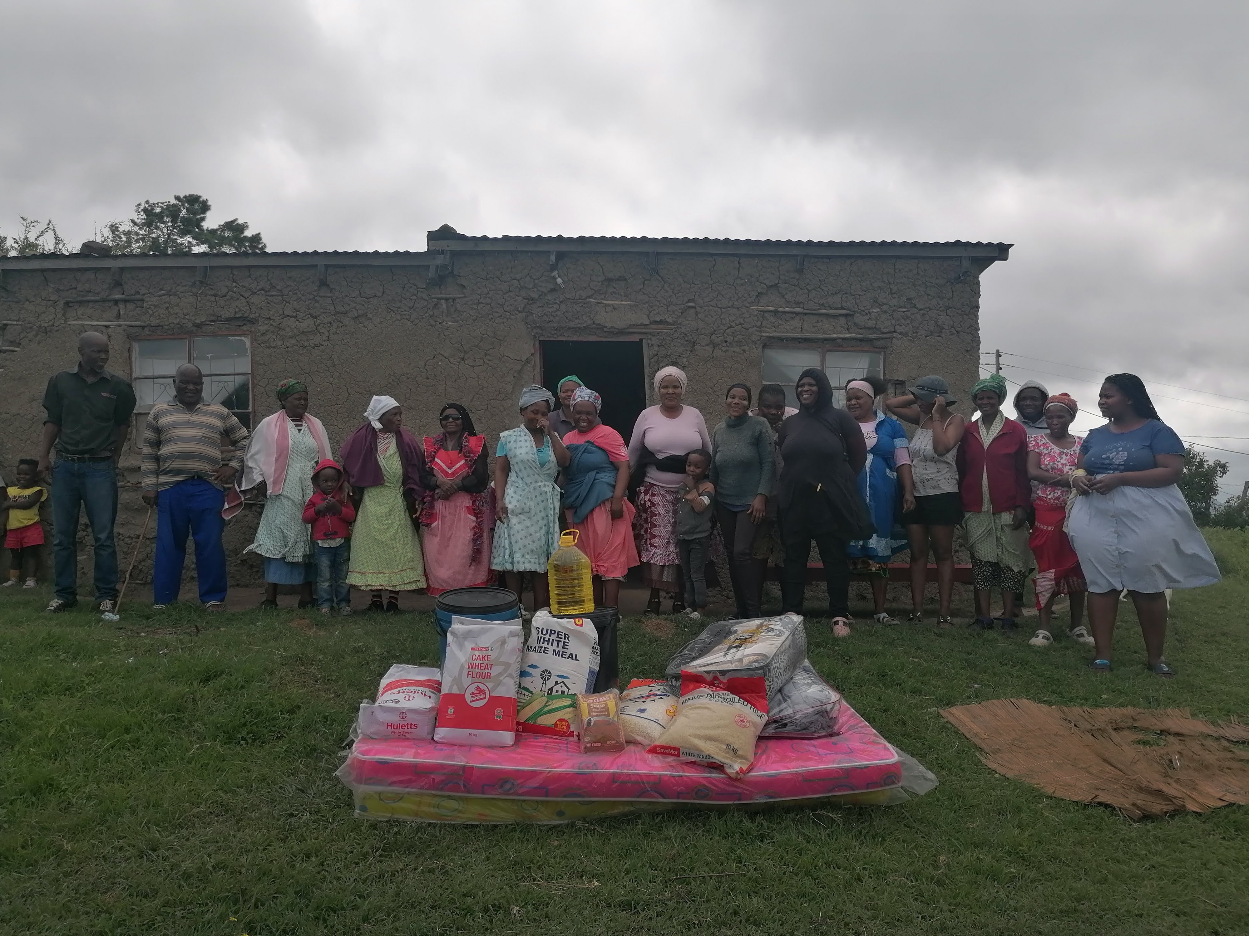 Community members gathered with mattresses and emergency supplies
