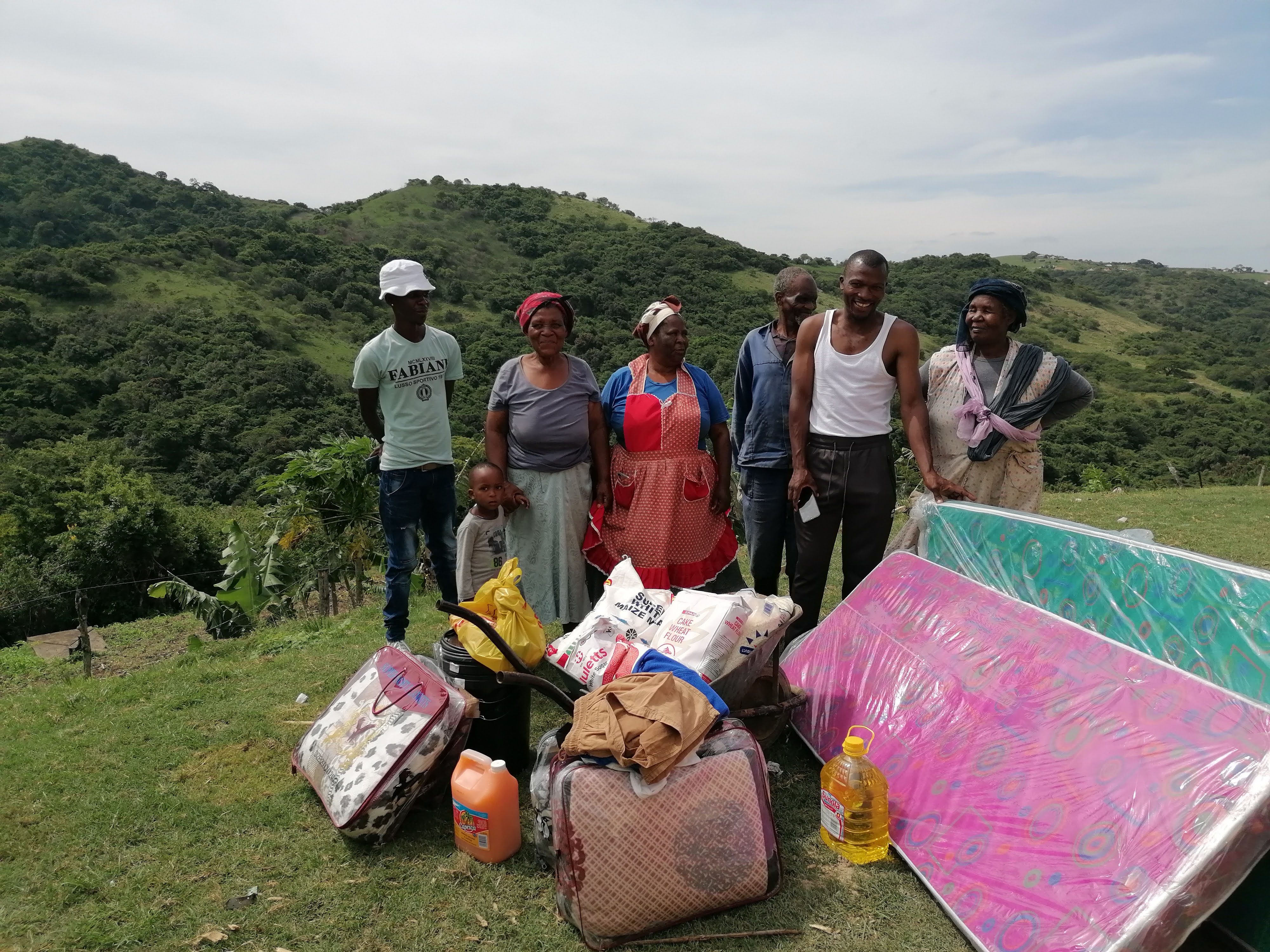 Family with a mattress, food and an emergency relief bundle