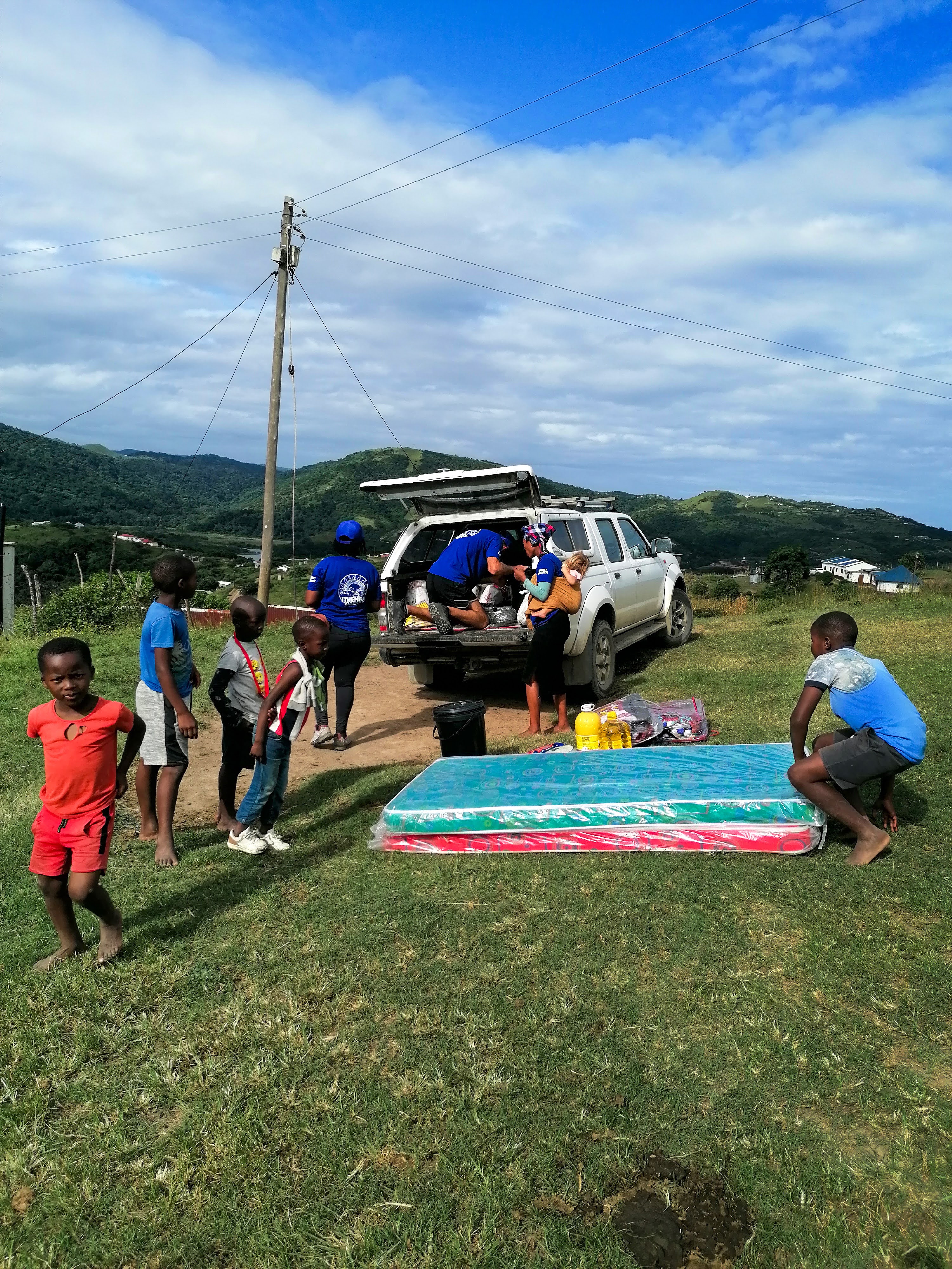 Local response team unloading mattresses and emergency supplies