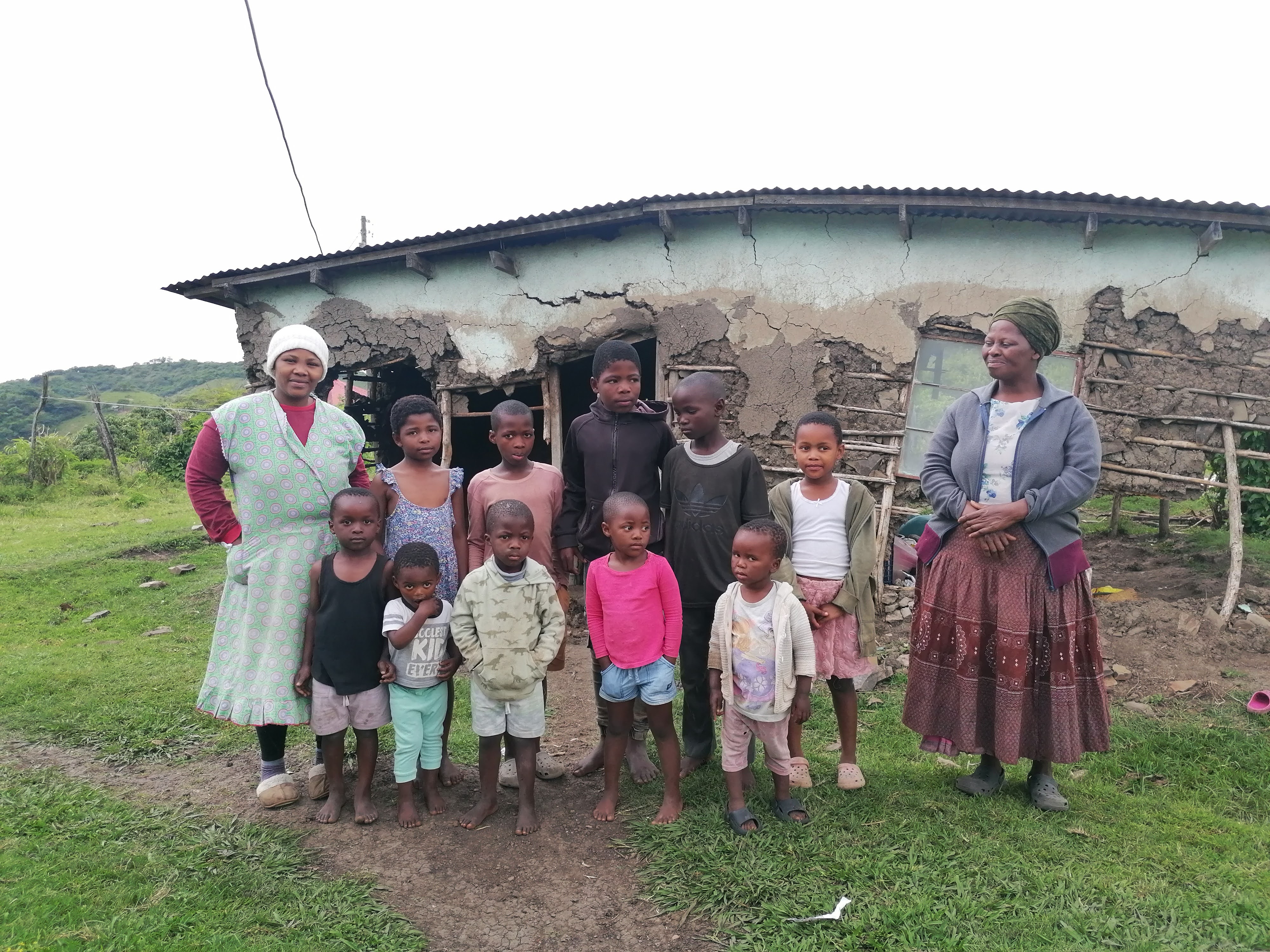Family gathered outside their rural home after receiving support
