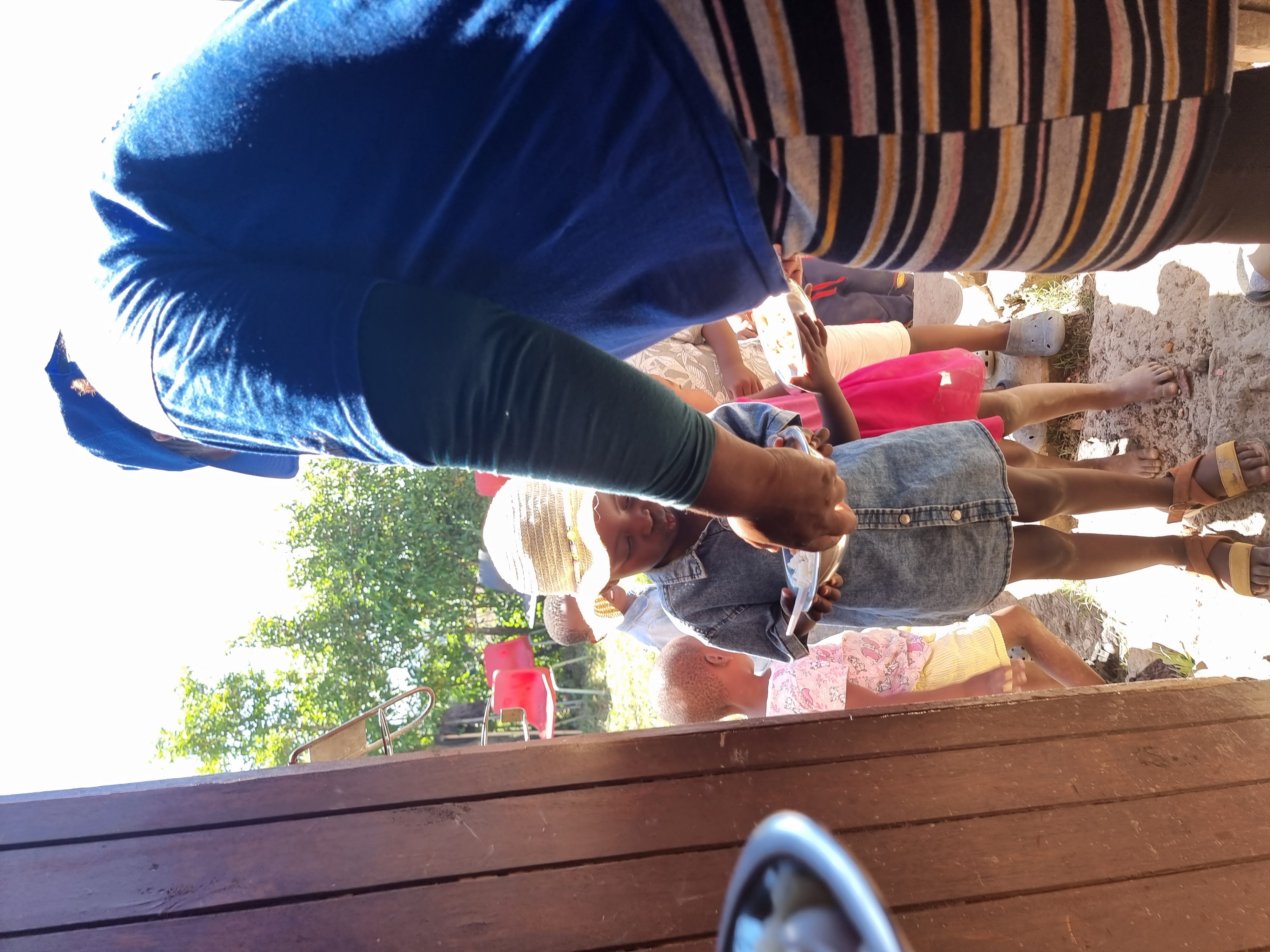 Worker serving meals from pots