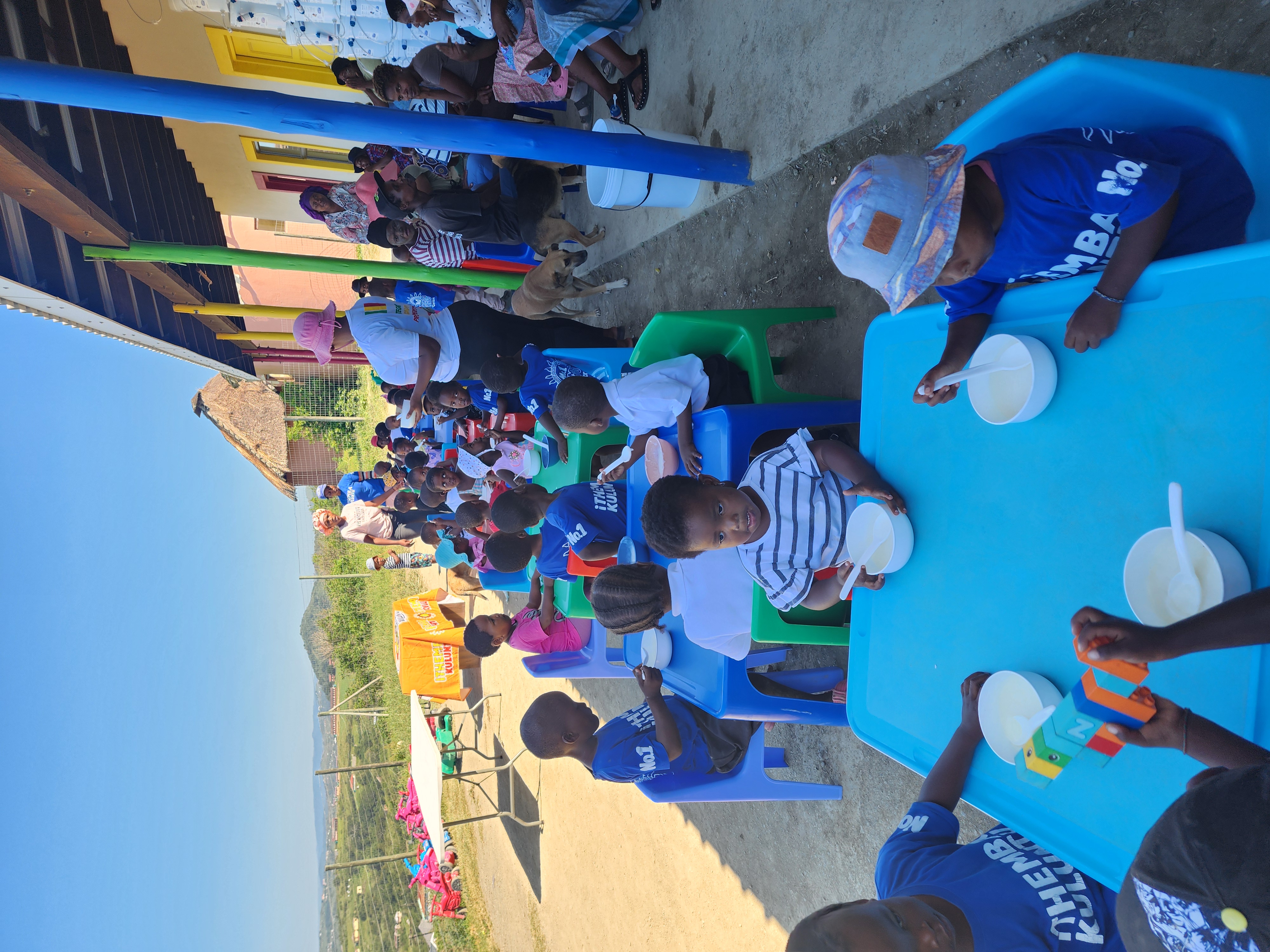 ECD children eating at blue tables