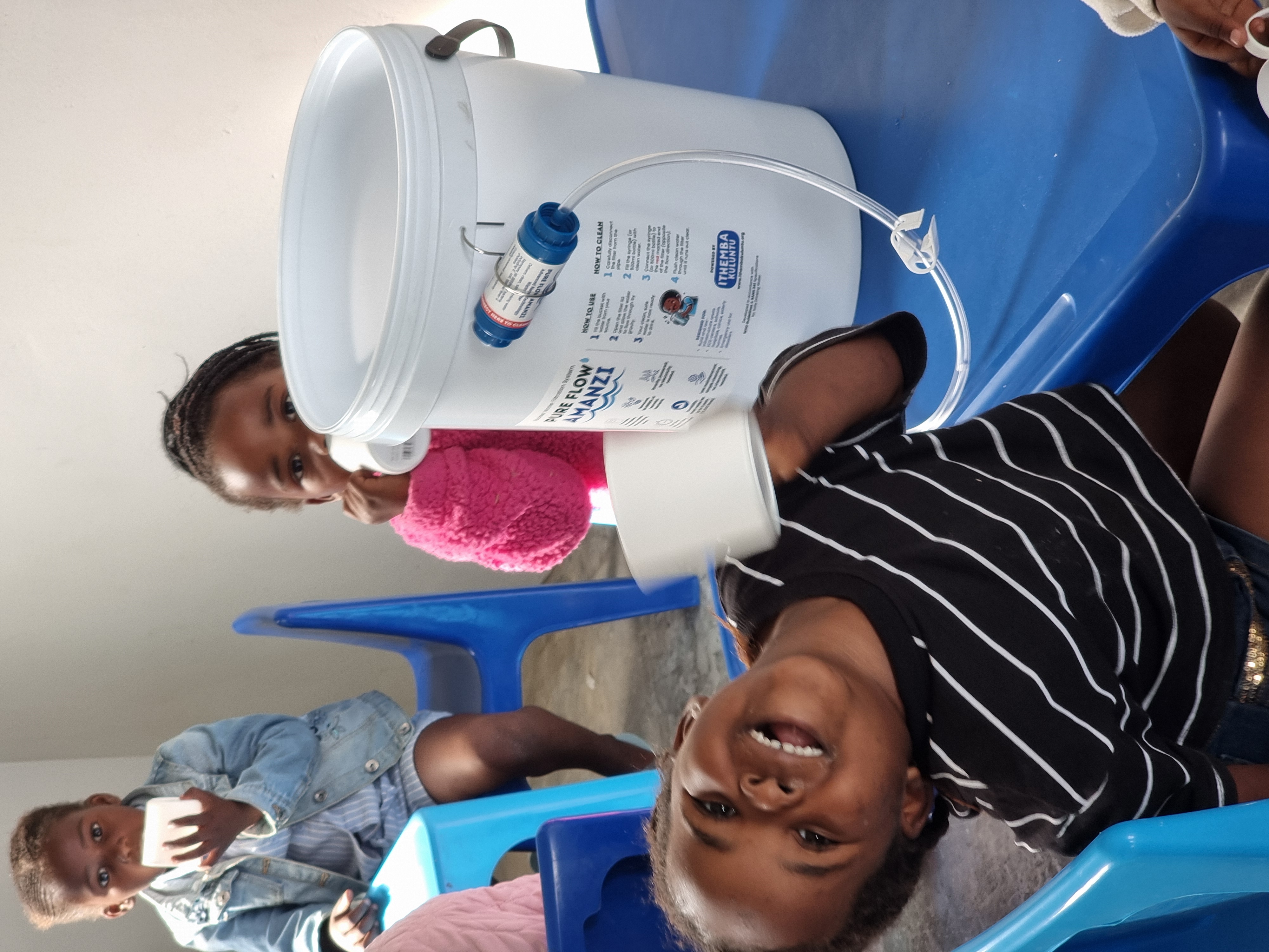 Child drinking filtered water at an ECD handout
