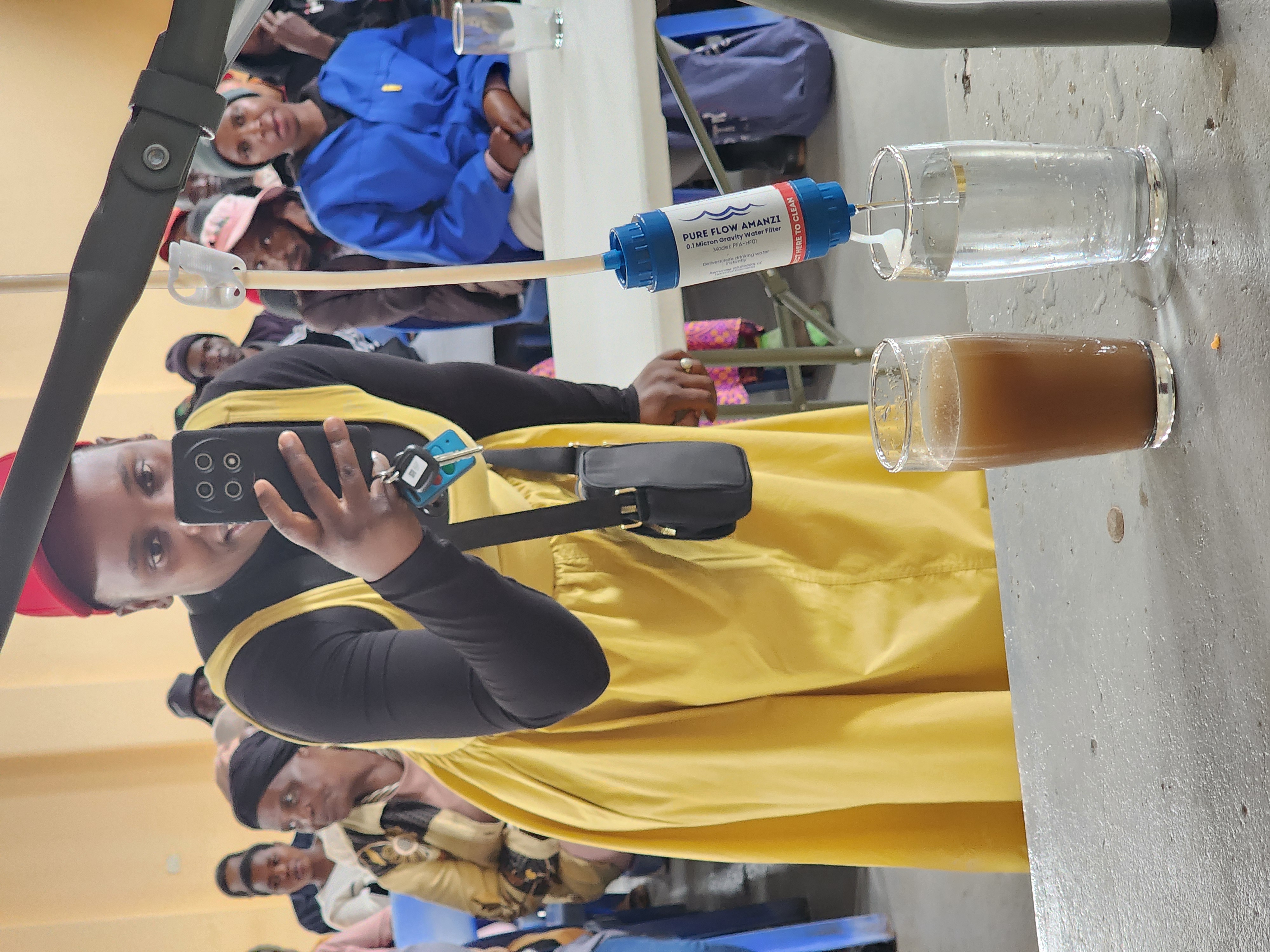 Woman comparing untreated and filtered water