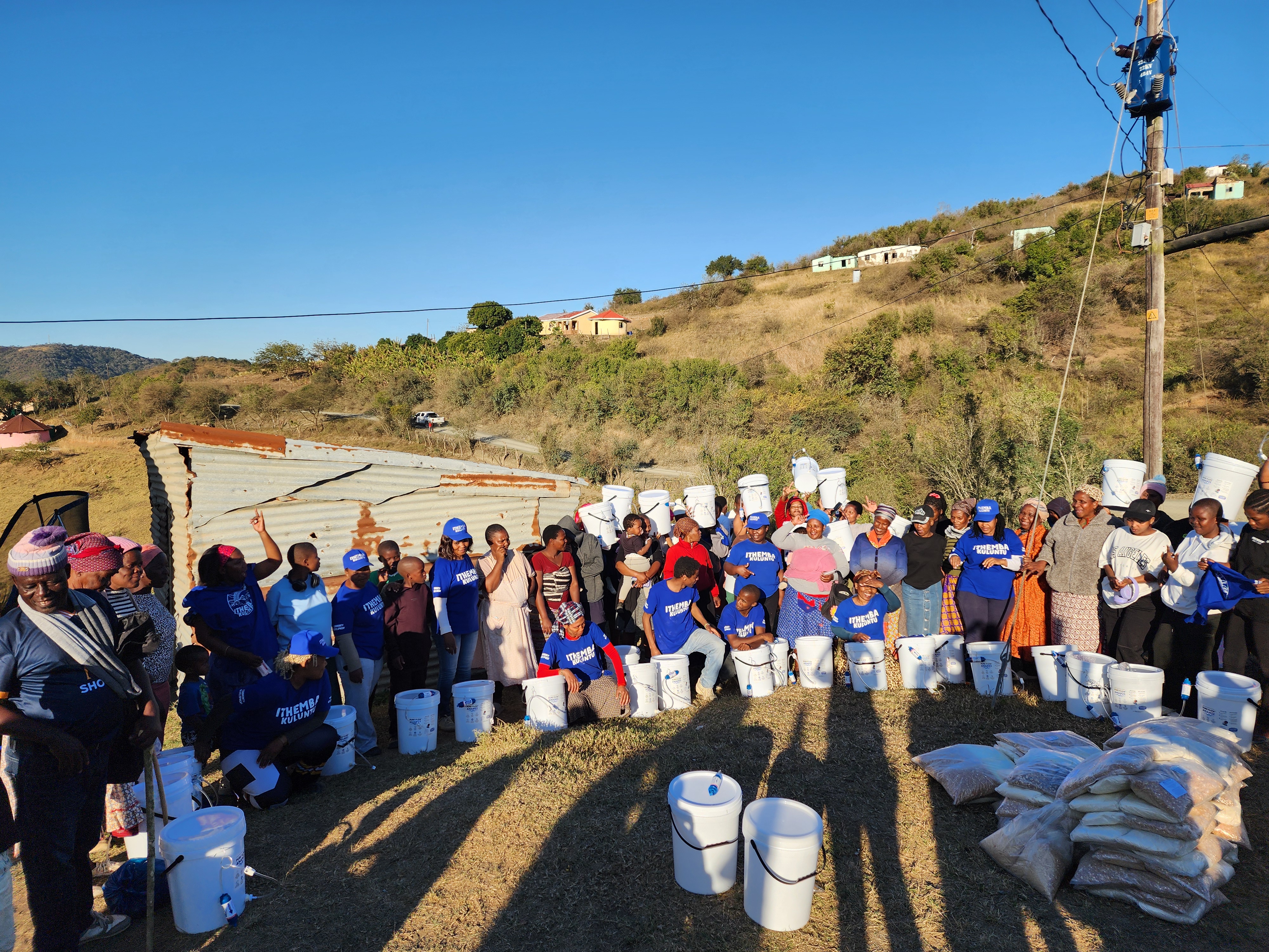 PureFlow Amanzi community members with household water filters