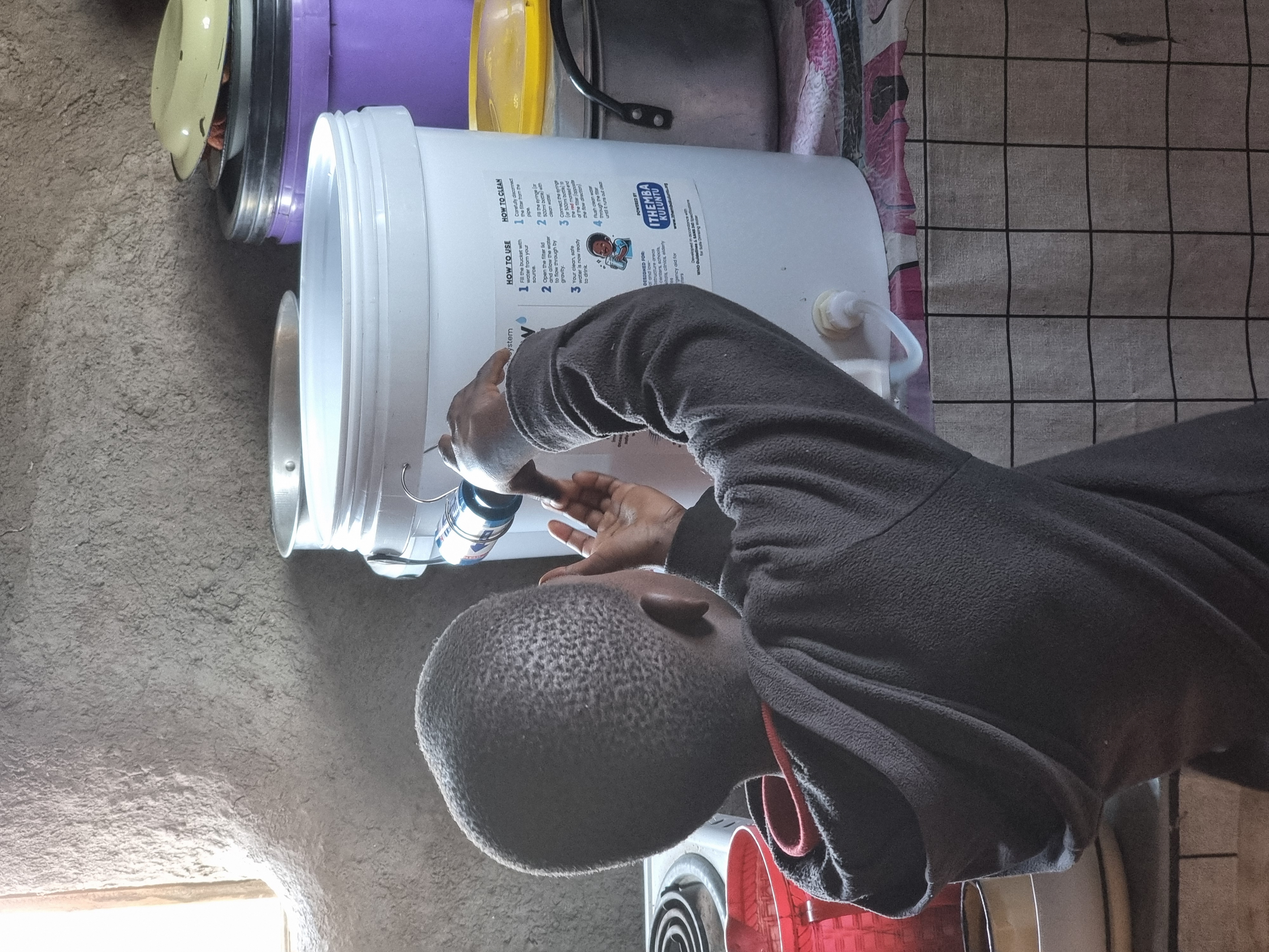 Child operating a PureFlow filter at home